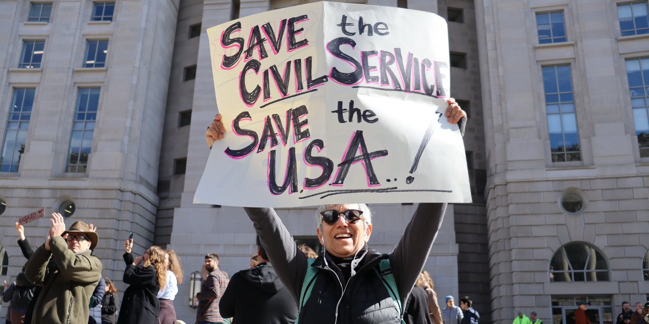 Independent public servants are a prerequisite for a functioning democracy. Photo from a protest outside the USAID HQ.
